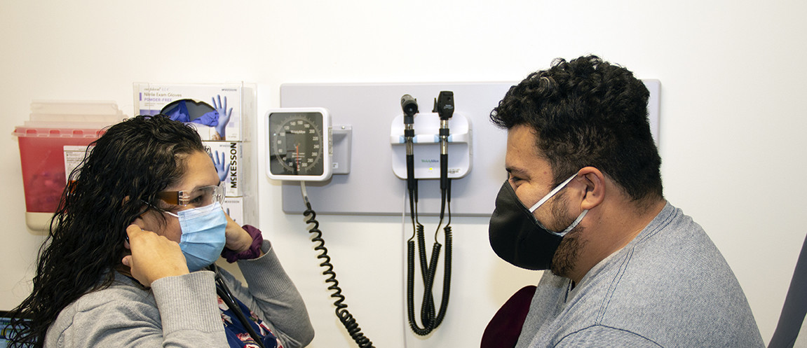 A provider in an exam room with a patient.