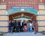 Group of Thundermist leaders and local dignitaries in front of Villa Nova School.