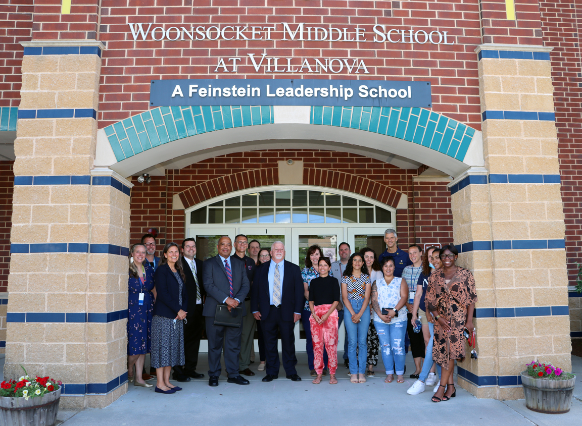 Group of Thundermist leaders and local dignitaries in front of Villa Nova School.