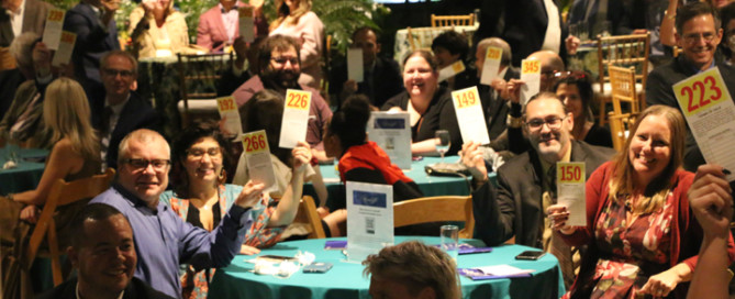 Bidders with raised paddles at Moonlight 2022.